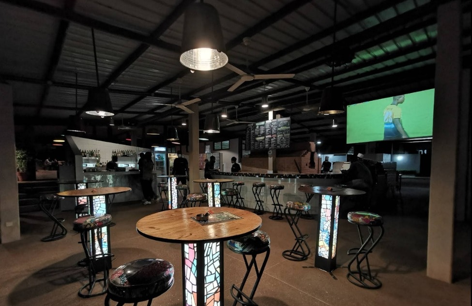 Le bar de Factory, tables hautes et fauteuils au crépuscule